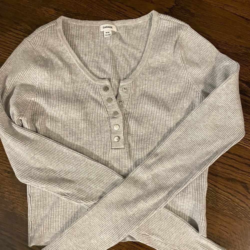 Garage:Henley snap front ribbed long sleeve crop top.